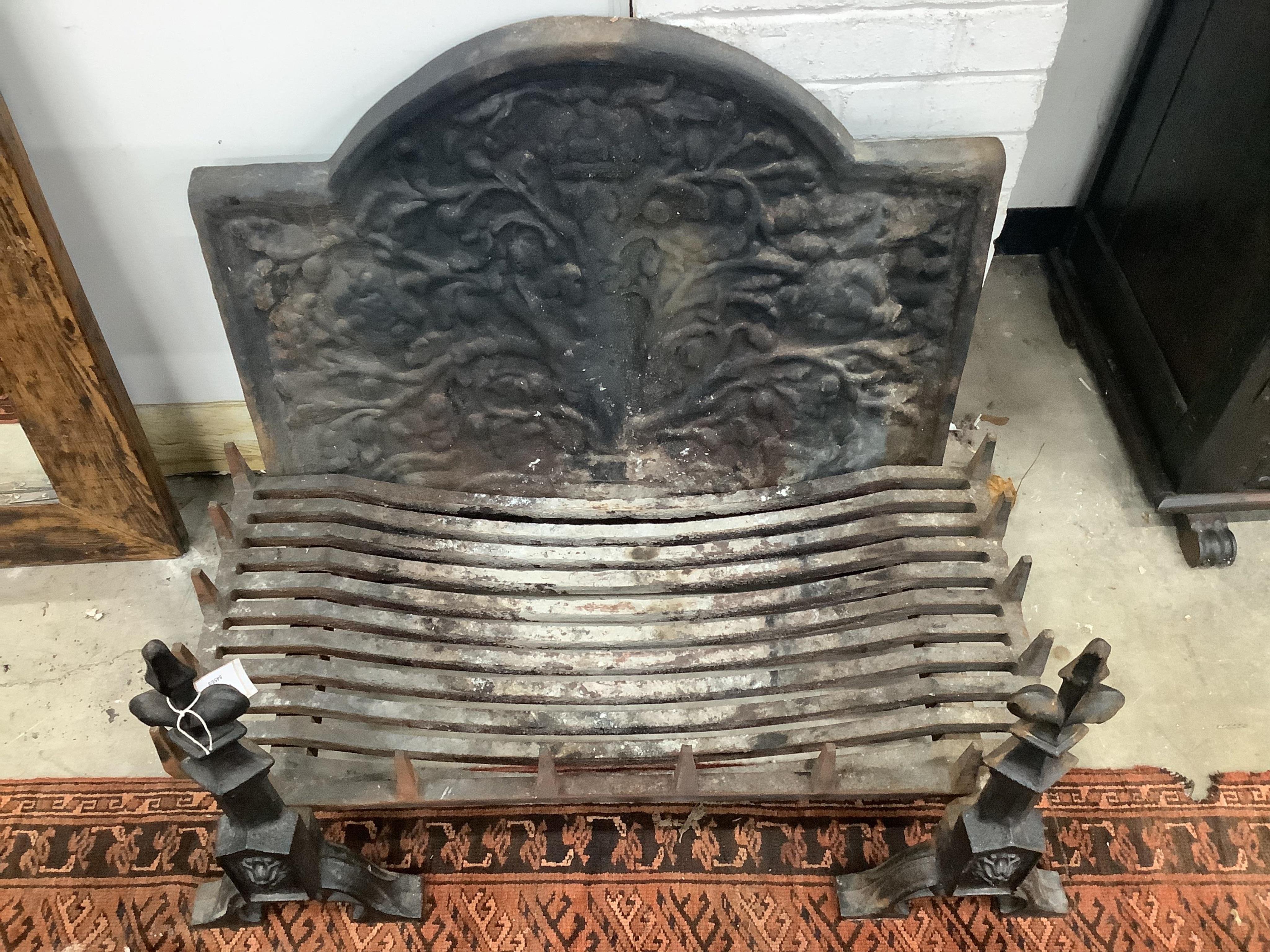 A cast iron fireback together with a fire grate, width 92cm, height 72cm and supporting fire dogs. Condition - fair